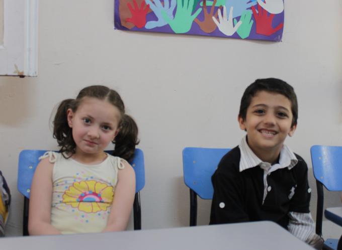 Malik* and Fatima*, both seven years old, learning at one of Save the Children’s supported community centres