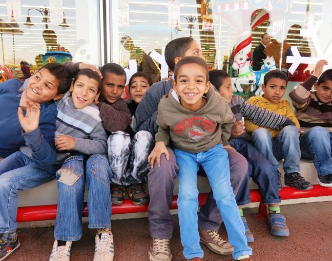 Boys from a local orphanage enjoying their outing to the supermarket, where they buy new winter clothes with vouchers provided by Save the Children